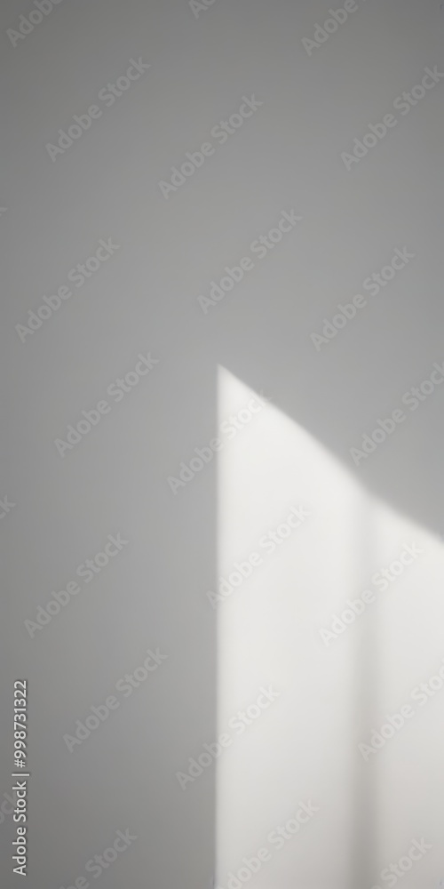 Aufkleber A simple, abstract light source casting a shadow on a plain white wall