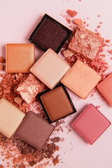collection of crushed makeup eyeshadow squares in warm, earthy tones