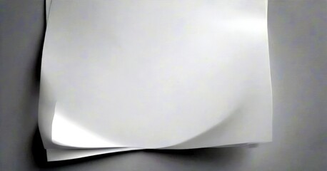 A white sheet of paper is slightly curled, creating a dynamic and textured composition against a plain gray background