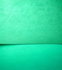 Fototapeta premium A close-up view green paper surface with a subtle texture, overlaid on a solid green background
