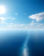 Obraz premium A serene vast, calm ocean under a clear blue sky with scattered clouds, captured from a high vantage point