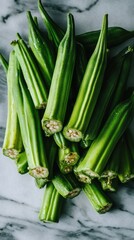 Obraz premium Fresh okra vegetables piled up on marble background