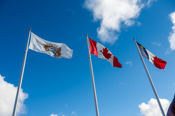 Acadian and canadian flag together