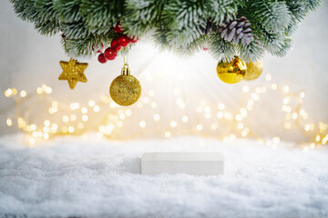 Christmas Holiday background with snow, fir tree and decorations with christmas light behind. Christmas podium for product demonstration on a winter festive background.