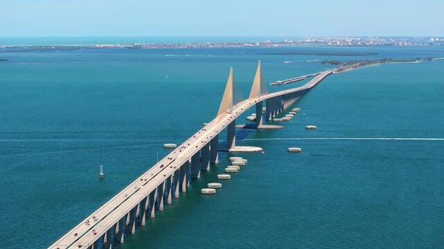 Highway road with driving traffic cars on Sunshine Skyway Bridge over Tampa Bay in Florida. Transportation infrastructure in USA