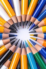 Fototapeta premium Colorful pencils arranged in a circular pattern on a white background.