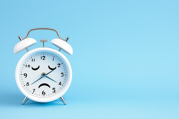 Alarm clock with sad face conveys feeling of Blue Monday and its emotional weight
