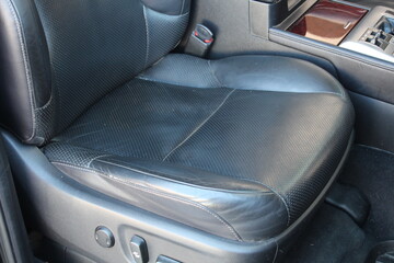 Obraz premium Leather SUV seat with electric adjustments. Electric driver seat buttons. Button for adjusting the car electric seat. Lux car leather driver seat. Black leather car interior.