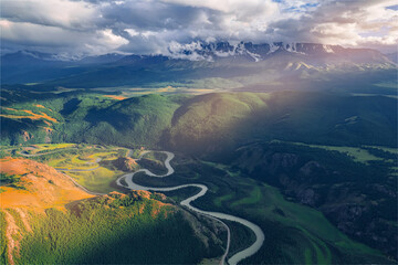 Beautiful autumn landscape with blue meanders winding river with yellow trees Altai mountains, Siberia, Russia. Aerial top view photo