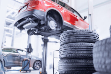 Closeup wheel of car in garage. Banner professional mechanic changing tires. © Parilov