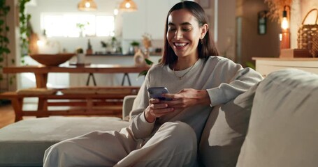 Woman, phone and fist pump for celebration on sofa, smile and excited for good news, prize or giveaway in home. Person, smartphone and success with investment, profit or mobile app with cheers