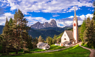 Val Gardena, South Tyrol, Italy. Alpine scenery. Beautiful Dolomites mountains. view of San Giacomo church near Ortisei village. .