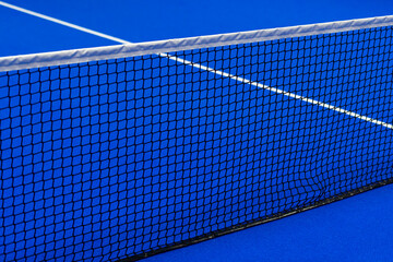 Paddle tennis and tennis net on blue court. Tennis competion concept. Horizontal sport poster, greeting cards, headers, website