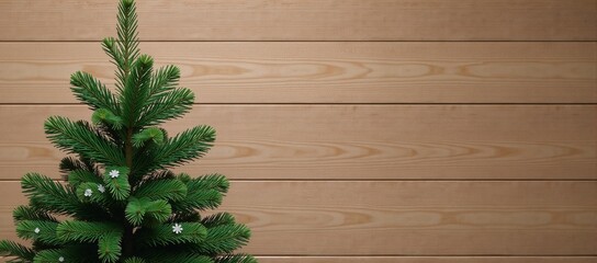 A Christmas fir tree sits against a wooden background with snowflakes falling