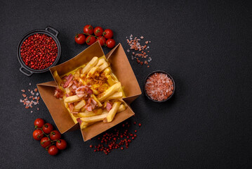 Crispy French fries with pieces of bacon, salt and spices