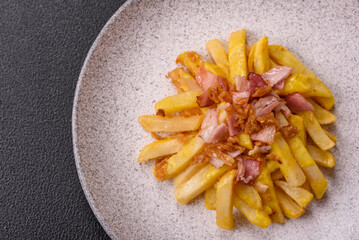 Crispy French fries with pieces of bacon, salt and spices