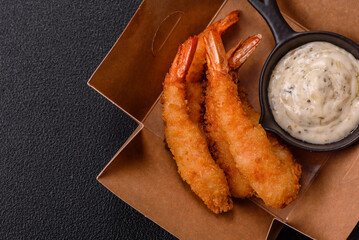 Hot crispy shrimp breaded with salt and spices with white sauce