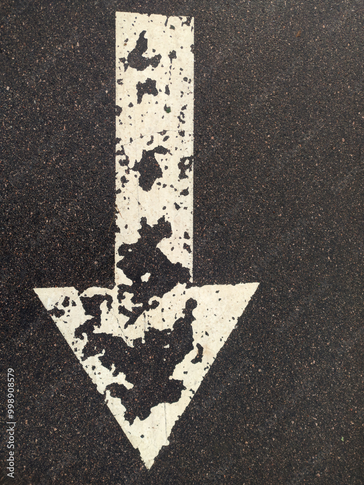 Poster A simple yet effective way to mark a path, this image features a white arrow painted on the ground