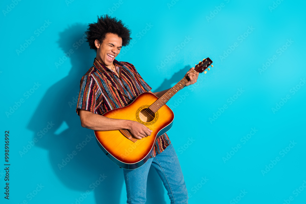 Canvas Prints Portrait of nice young man enjoy play guitar wear shirt isolated on turquoise color background