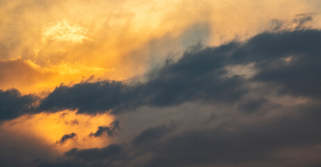 Sky background. Bright evening sunset sky with dramatic clouds.