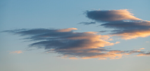 Sky background. Bright evening sunset sky with dramatic clouds.