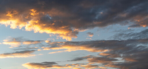 Sky background. Bright evening sunset sky with dramatic clouds.