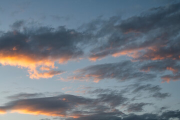 Fototapeta premium Sky background. Bright evening sunset sky with dramatic clouds.