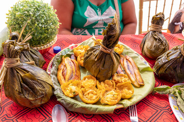 Chicken juane wrapped in bijao leaves. Peruvian jungle food, in all its varieties. Feast of San...