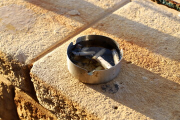 Ashtray for cigarettes and ash when smoking.