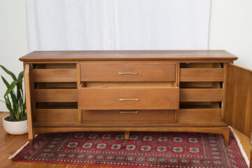 Vintage walnut dresser. Mid-century modern chest of drawers. Interior product photograph.