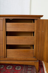 Fototapeta premium Vintage walnut dresser. Mid-century modern chest of drawers. Interior product photograph.