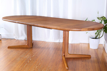 Dining table with extension leaves. Vintage solid teak furniture. Interior product photograph jpg.