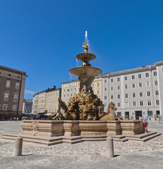 Fototapeta premium The fountain in focus within the square, Salzburg, Austria