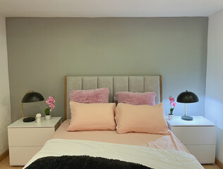 Minimalist and modern room with youthful tones and two side tables