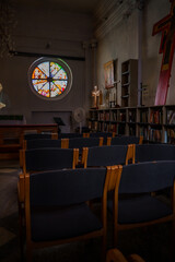 A hall with chairs and a stained glass window in the Lutheran Church Annenkirche. Saint Petersburg, Russia - 27 July 2024