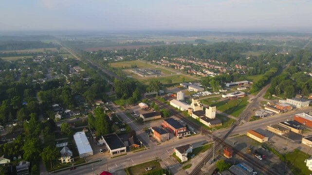 Small town with old grain elevator along train tracks in Carleton, Michigan, USA