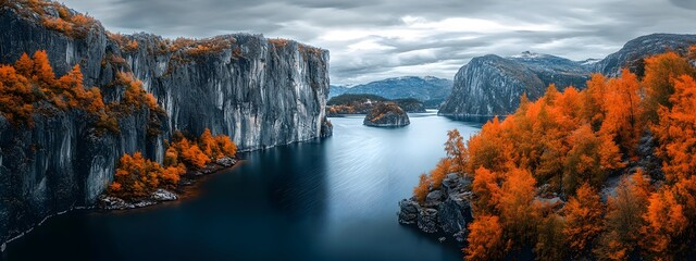 The deep blue water of the lake is surrounded by high cliffs and orange trees, with autumn colors