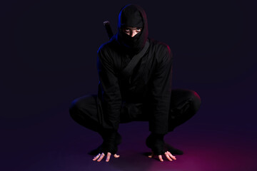 Male ninja on black background