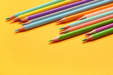 Group of colorful pencils on yellow background