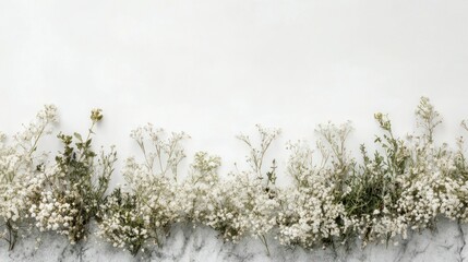 White Flowers and Green Leaves Along a White and Gray Marble Surface