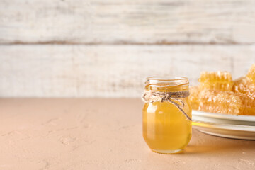 Jar with sweet honey on table
