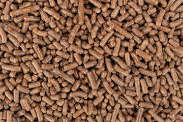 Overhead view of a layer of chocolate sprinkles.
