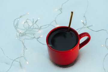 cup of coffee at winter time, cozy atmosphere on the snow