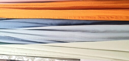 
Curtains assortment in the home decor store. New high-quality curtains goods. Fabric store. Interior design. Sale and purchase of curtains and drapes. Curtains assortment. Fabrics of different colors