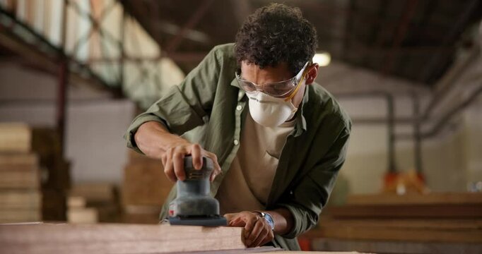 Wood, carpenter and sanding with machine of person in workshop for furniture, manufacturing and renovation. Production, tools and design factory, woodwork and handyman in warehouse for board polish