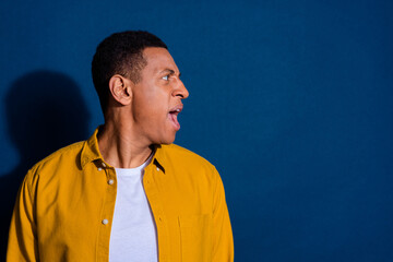 Fototapeta premium Photo of aggressive young guy wearing stylish shirt angry screaming mad looking empty space dissatisfied isolated on dark blue color background
