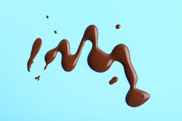 Sweet chocolate splashes on blue background