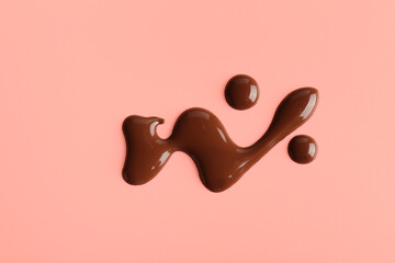 Sweet chocolate splashes on red background