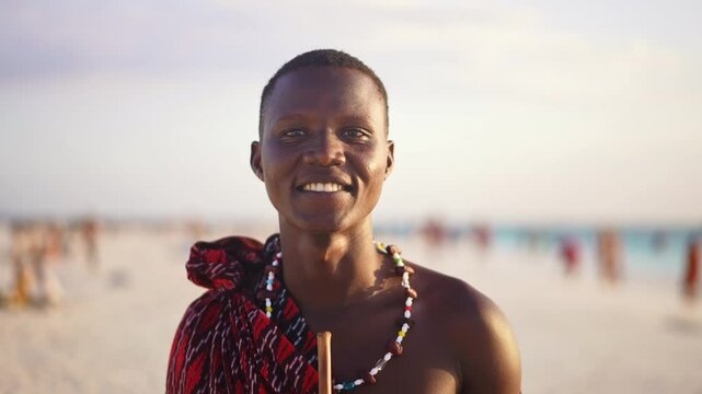 Portrait of Maasai man, traditional outfit, African warrior tribesman on beach. Tropical island beach in Tanzania. tourism destination in Africa. 