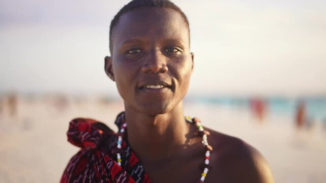 Portrait of Maasai man, traditional outfit, African warrior tribesman on beach. Tropical island beach in Tanzania. tourism destination in Africa. 